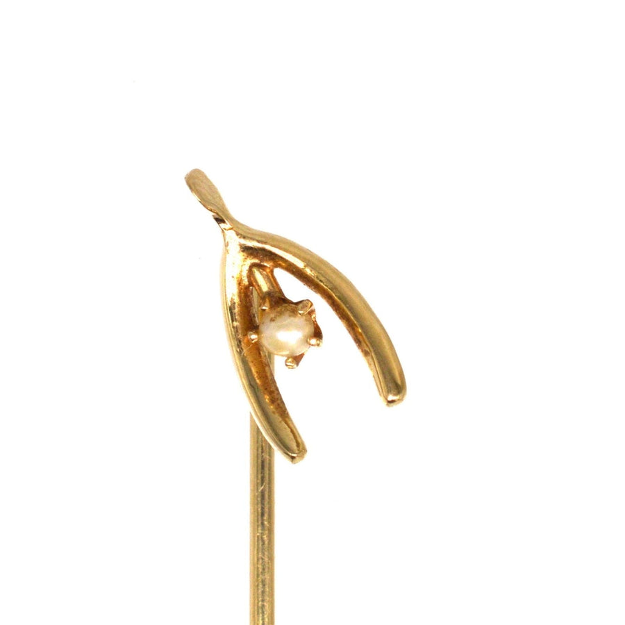Edwardian 15ct gold wishbone tie pin with a natural pearl, symbolizing luck and elegance for silk ties.