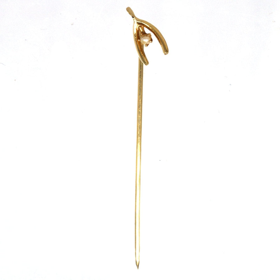 Edwardian 15ct gold wishbone tie pin with natural pearl, symbolizing good luck on a silk tie.