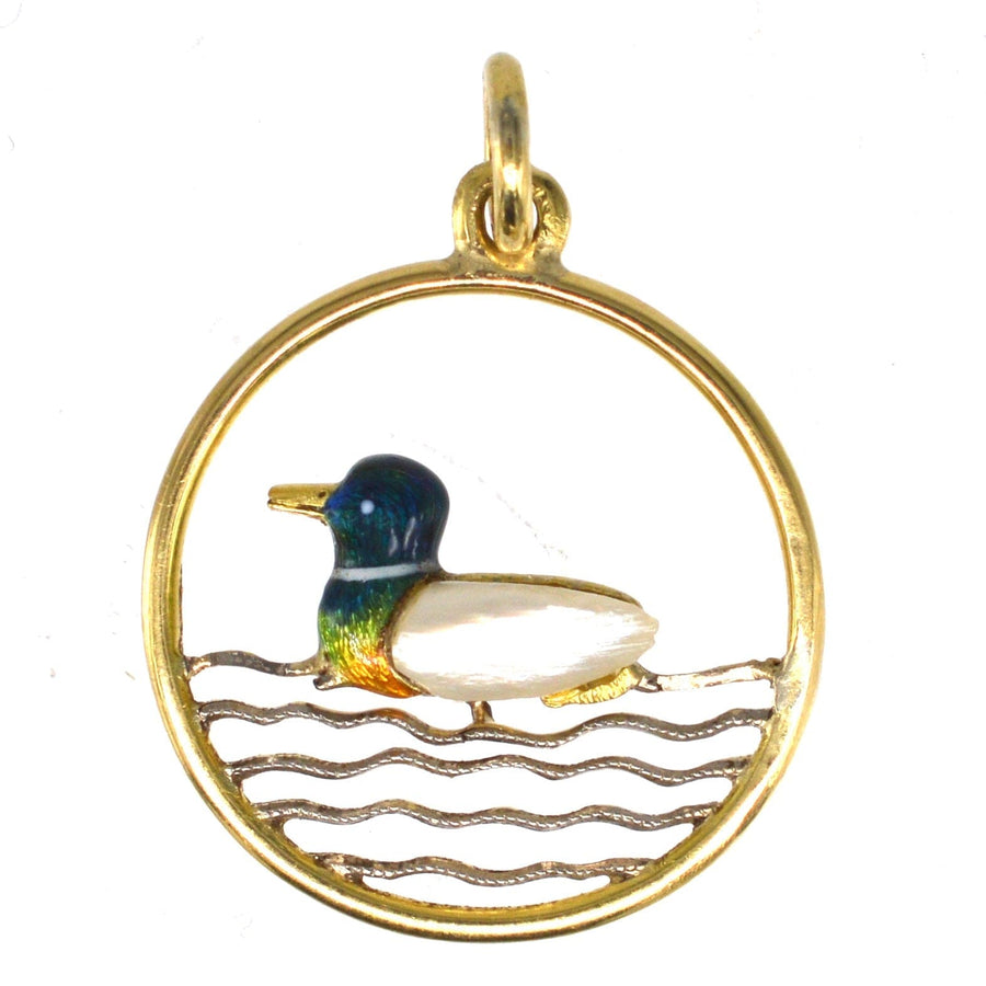 Edwardian 15ct gold duck pendant featuring baroque pearl, enamel details, and round frame.