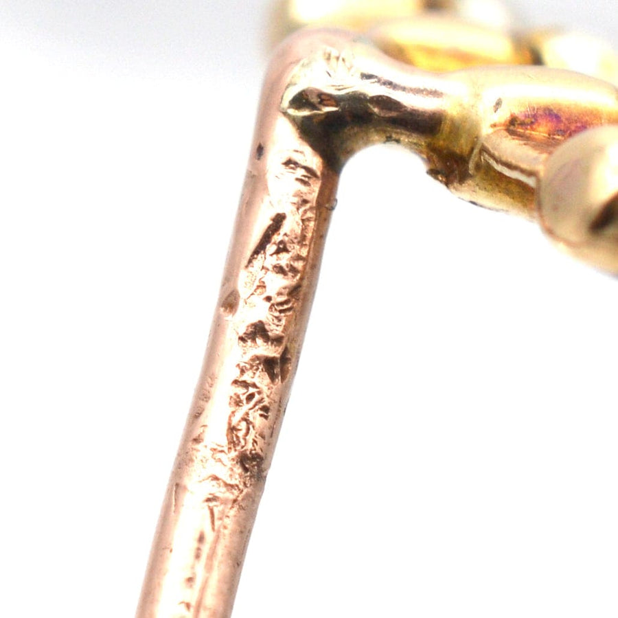 Close-up of an Edwardian 15ct gold tie pin showcasing intricate detailing and craftsmanship.