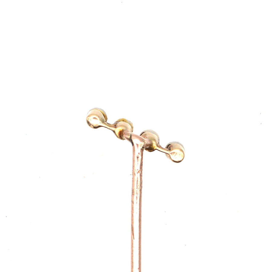 Edwardian 15ct gold tie pin featuring four natural pearls elegantly set on a diagonal bar.