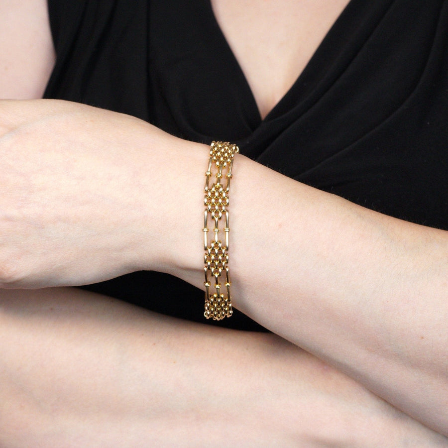 Edwardian 15ct gold gate bracelet worn on a wrist, showcasing its classic and elegant design.