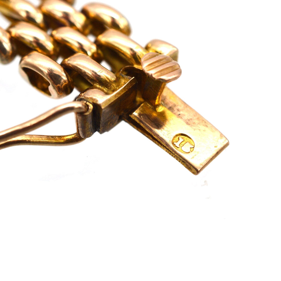 Detail of a vintage Edwardian 15ct gold gate bracelet clasp with turquoise accents.