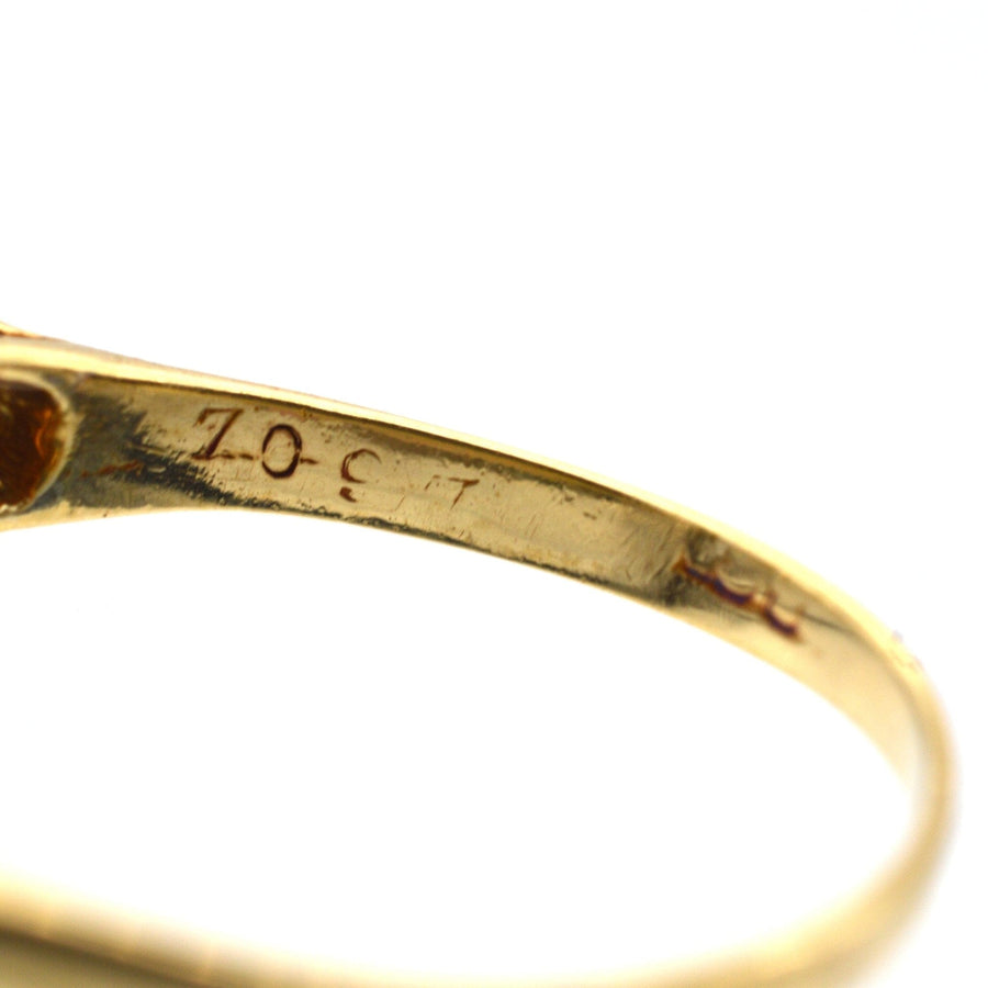 Close-up of inner band of a 15ct gold ring showcasing elegant engraving and craftsmanship.