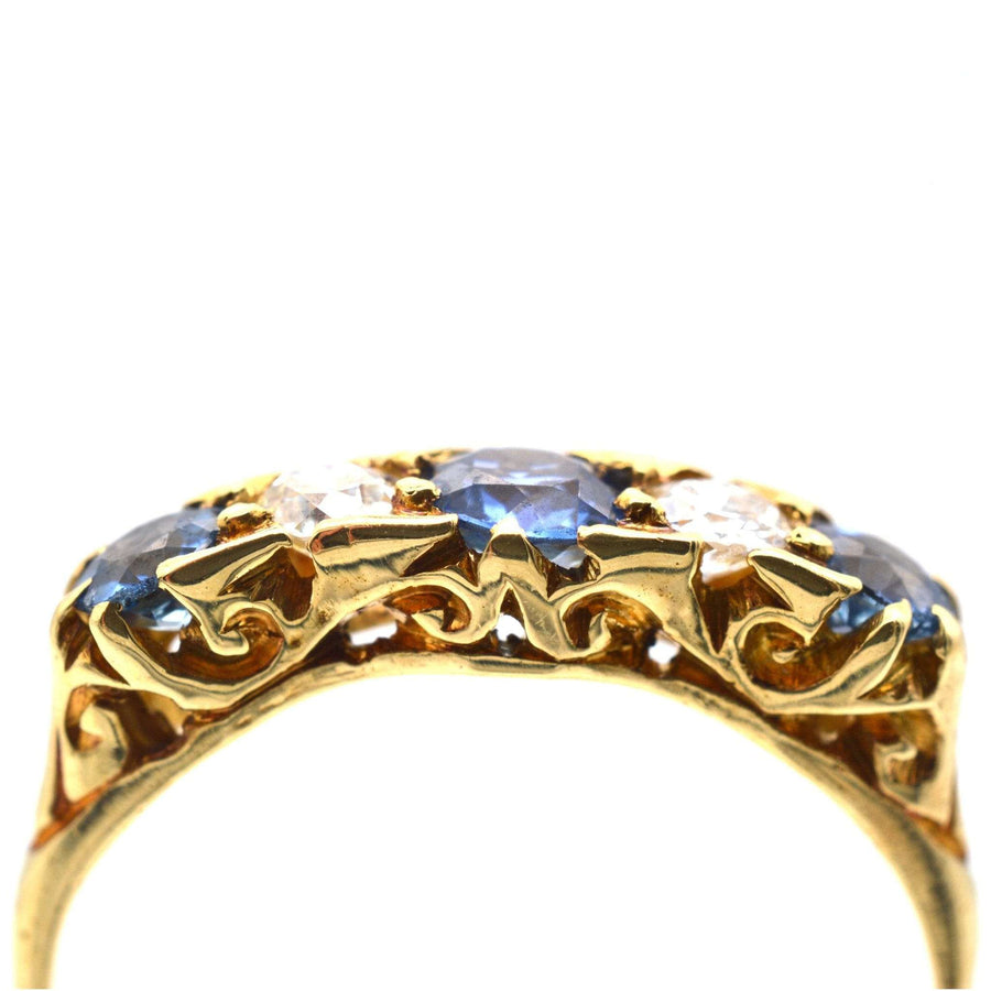 Edwardian 15ct gold five stone ring featuring cornflower blue sapphires and diamonds, perfect for engagements.
