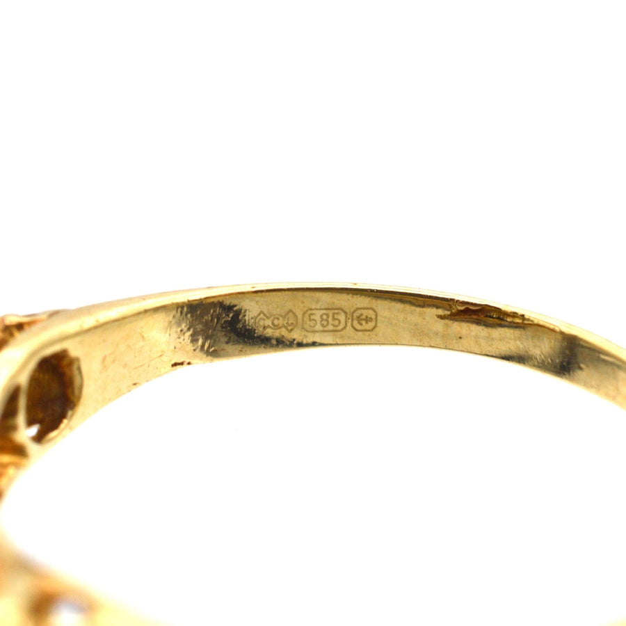 Close-up of the inside of an Edwardian gold ring, showing hallmark and quality stamp for 15ct gold.