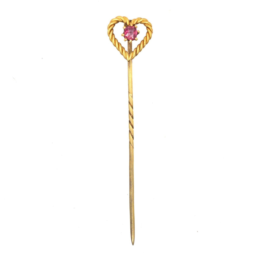 Edwardian 15ct gold heart tie pin with ruby, showcasing fine craftsmanship and playful design, perfect for any occasion.