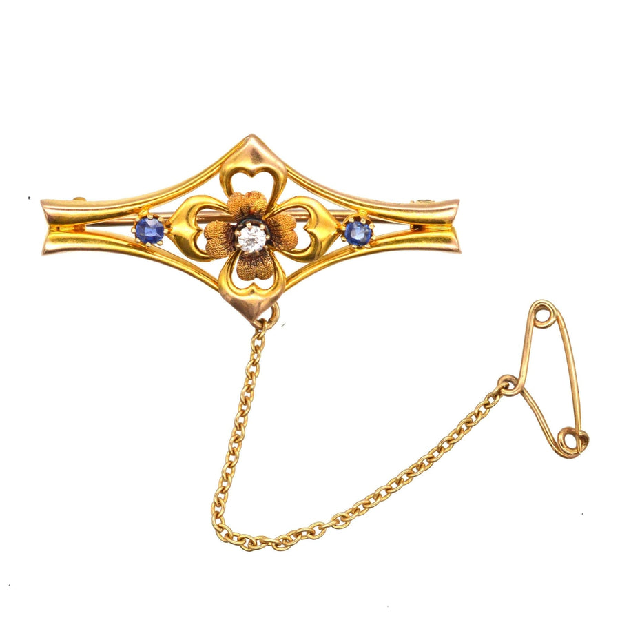 Edwardian 15ct gold flower bar brooch with diamond and sapphire accents, crafted in 1910 in Chester.