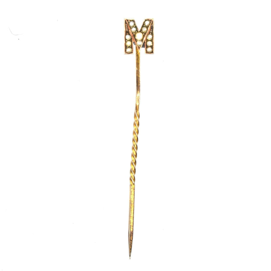 Edwardian 15ct gold tie pin in the shape of letter 'M' adorned with twelve seed pearls, stylish accessory for silk ties.