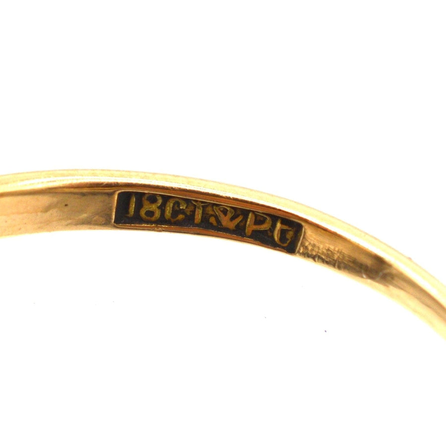 Close-up of the hallmark showing 18ct gold and platinum certification on a vintage ring.