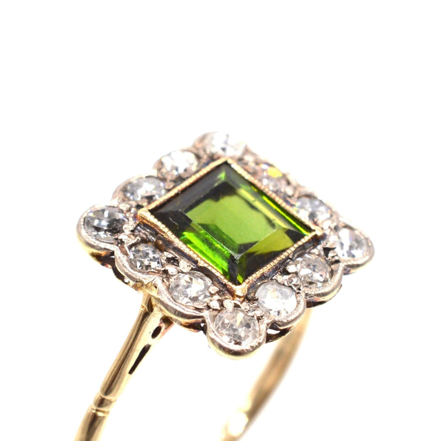 Edwardian 18ct gold and platinum ring featuring a vibrant green tourmaline and diamond cluster design.