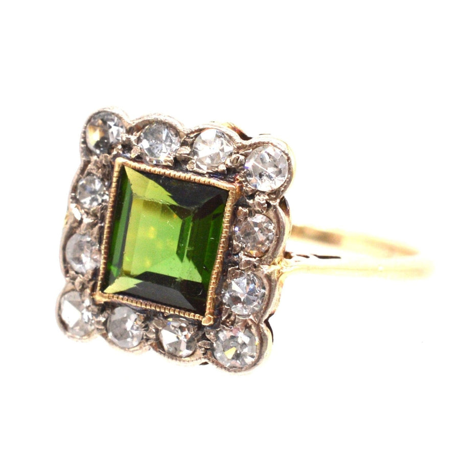 Edwardian 18ct gold and platinum cluster ring with green tourmaline and twelve diamond accents.
