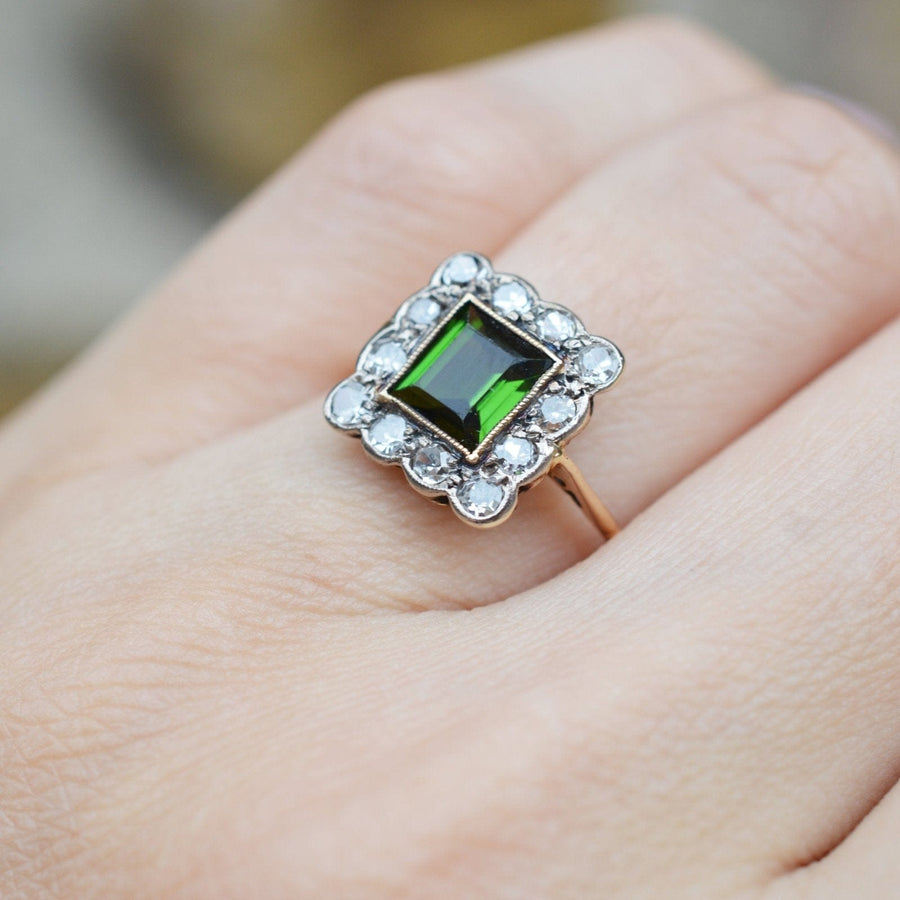 Edwardian 18ct gold and platinum cluster ring featuring a vibrant green tourmaline and sparkling diamonds.