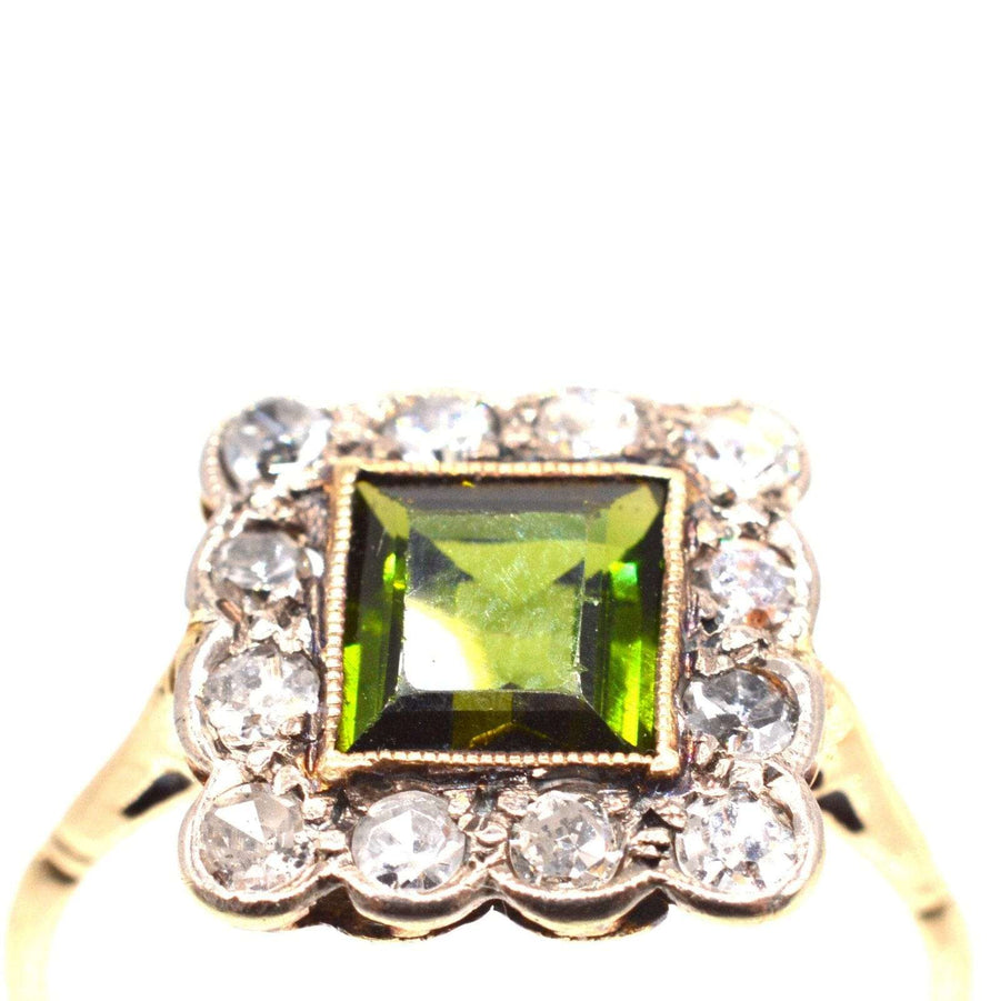 Edwardian 18ct gold and platinum ring featuring a green tourmaline and diamond square cluster design.