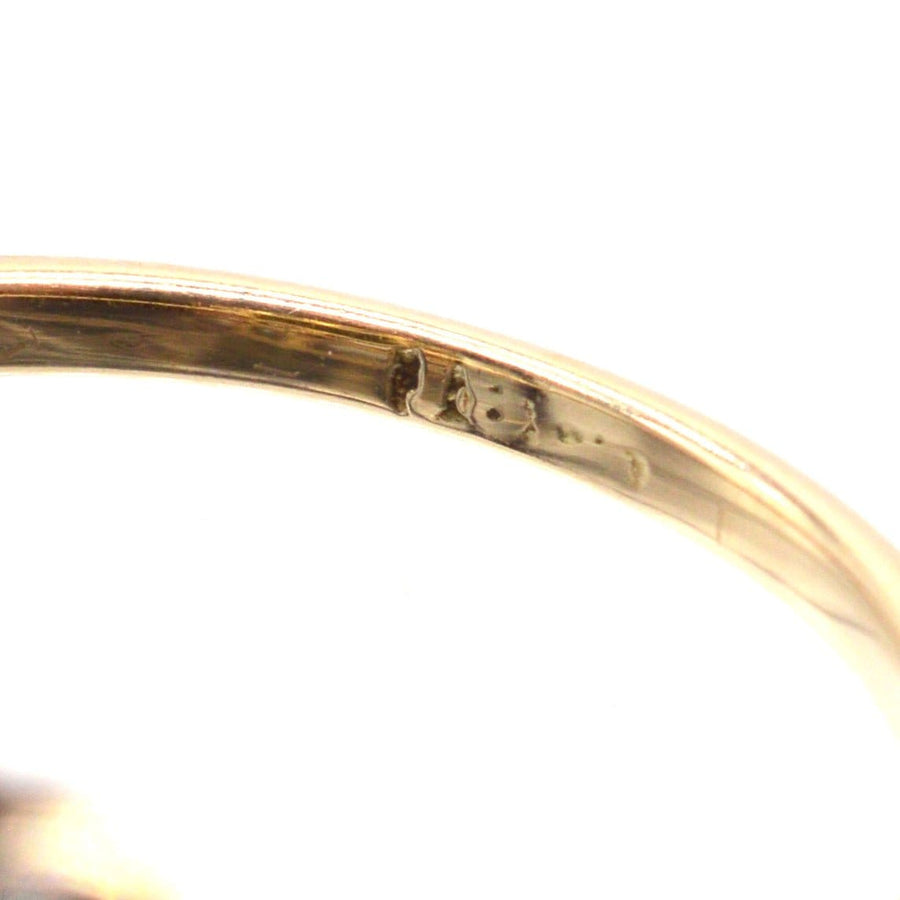 Close-up view of the hallmark inside an Edwardian 18ct gold and platinum cluster ring.