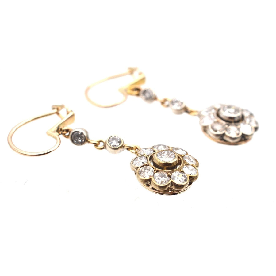 Elegant Edwardian 18ct gold diamond cluster drop earrings with intricate floral design.