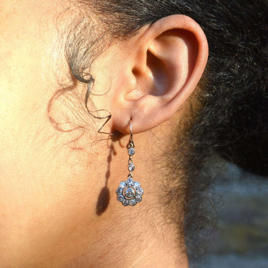 Edwardian 18ct gold diamond cluster drop earrings worn by a model, showcasing elegance and vintage style.