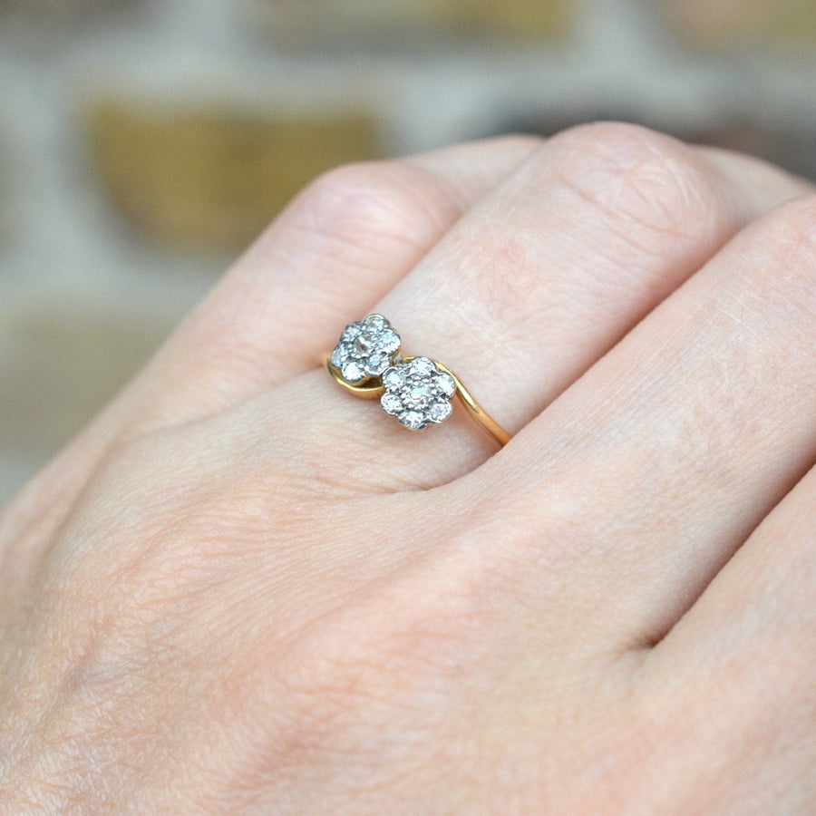 Edwardian 18ct gold crossover ring with two diamond flower clusters, ideal for engagement or special occasions.