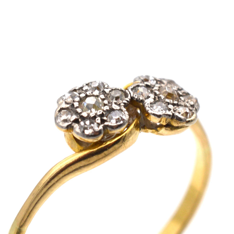 Edwardian 18ct gold double diamond cluster crossover ring featuring delicate floral design.