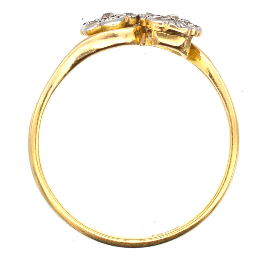 Edwardian 18ct gold crossover ring featuring two diamond flowers, perfect for engagements.