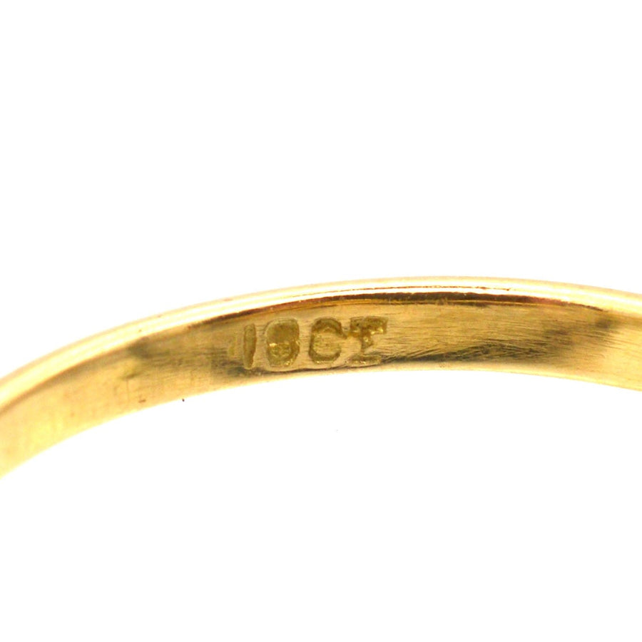 Close-up of a 18ct gold hallmark on a vintage ring, showcasing its quality and craftsmanship.