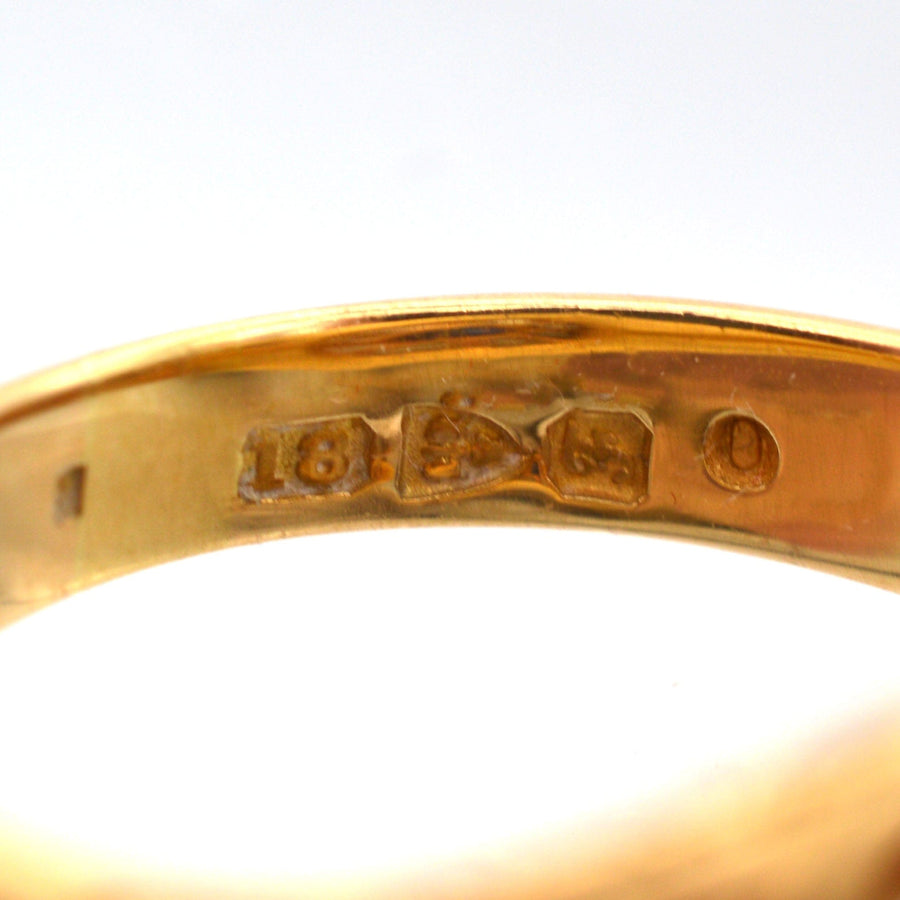 Close-up of the hallmark on the inside of an Edwardian 18ct gold ring, featuring 1906 Chester markings.