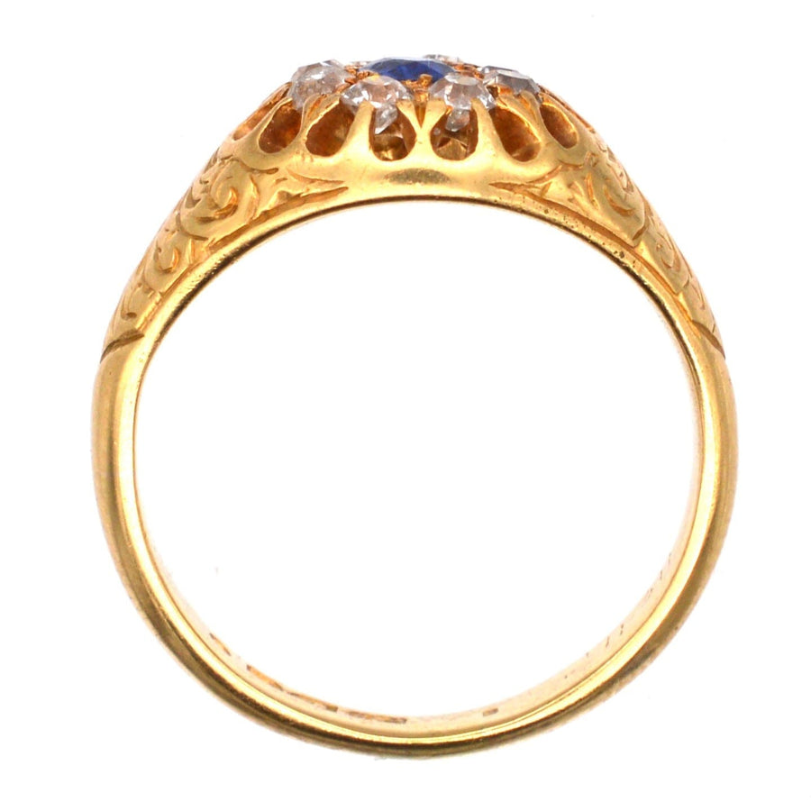 Edwardian 18ct gold cluster ring with sapphire and old mine cut diamonds, engraved foliate design.