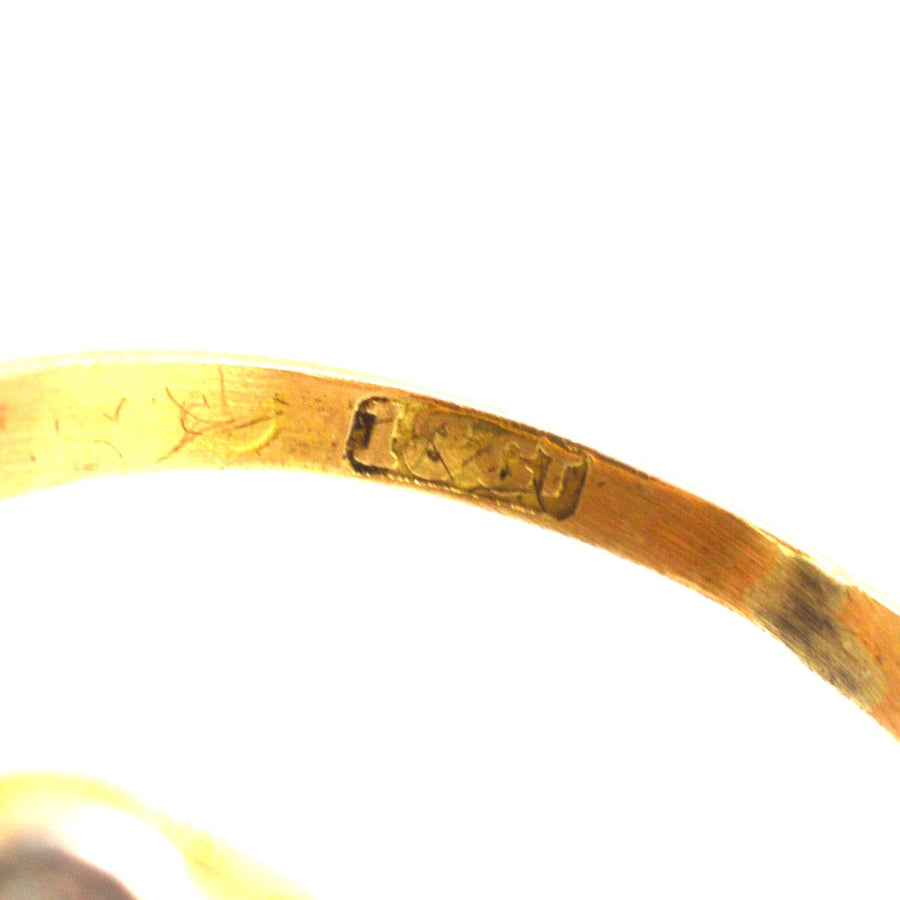 Close-up of the inner band of an Edwardian 18ct gold ring, showing the engraved hallmark.