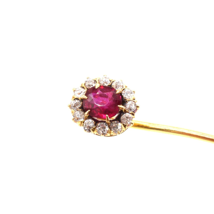 Edwardian 18ct gold tie pin featuring a vibrant pigeon blood ruby surrounded by sparkling diamonds.