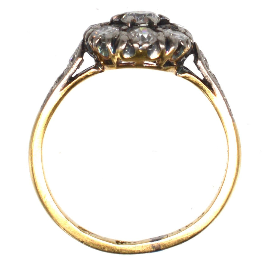 Edwardian 18ct gold and platinum diamond cluster ring showcasing a unique design and sparkling diamonds.