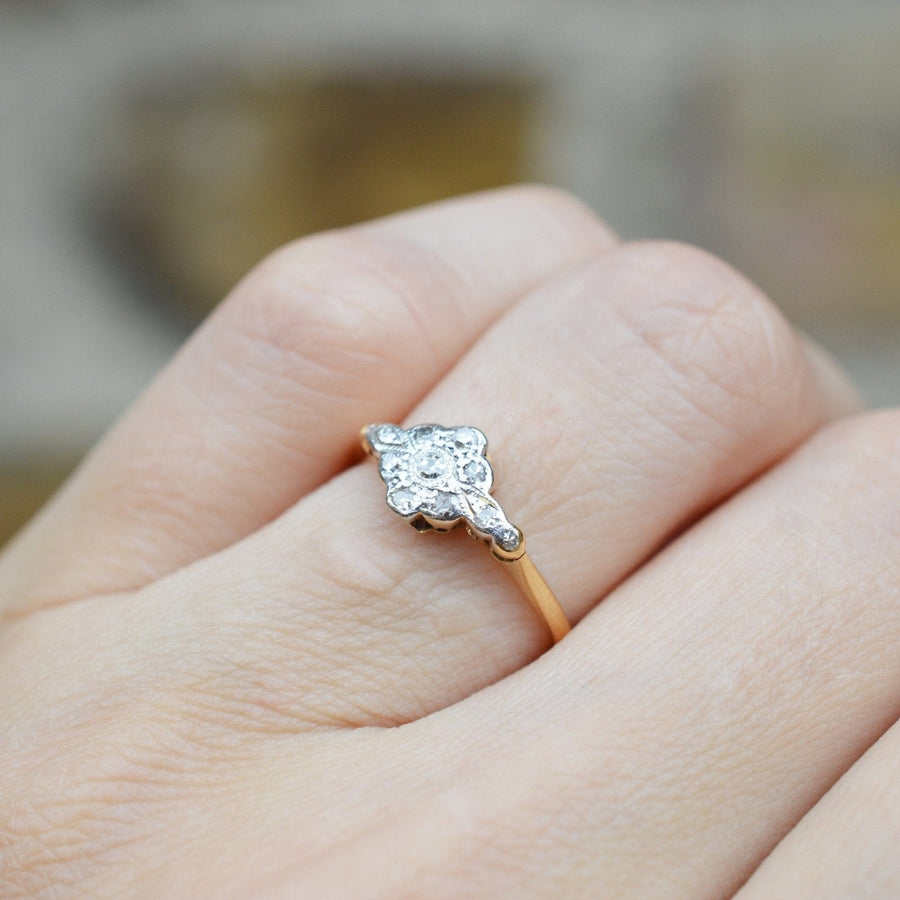 Edwardian diamond cluster ring in 18ct gold and platinum, showcasing unique design and vintage elegance.