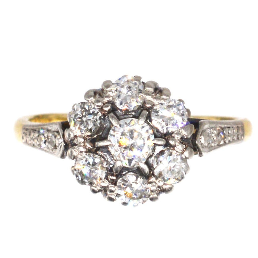 Edwardian 18ct gold and platinum diamond cluster ring featuring 0.70 carats of diamonds, perfect as an engagement ring.