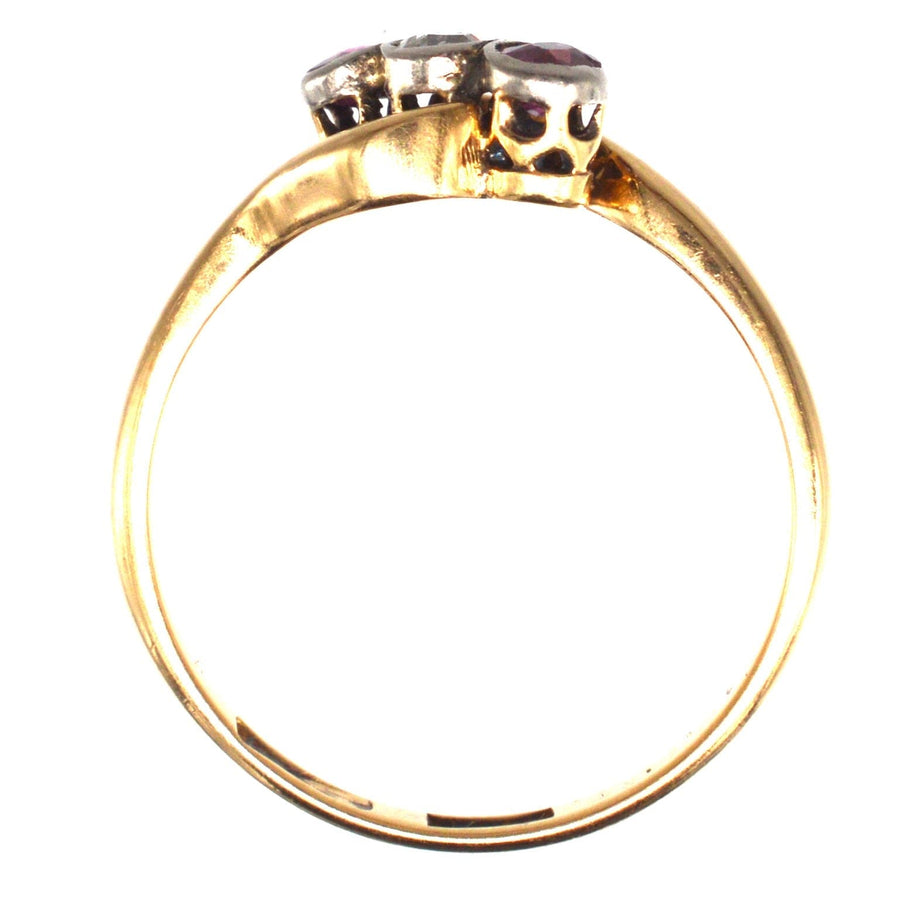Edwardian 18ct gold and platinum crossover ring featuring rubies and a diamond, showcasing Art Nouveau design.