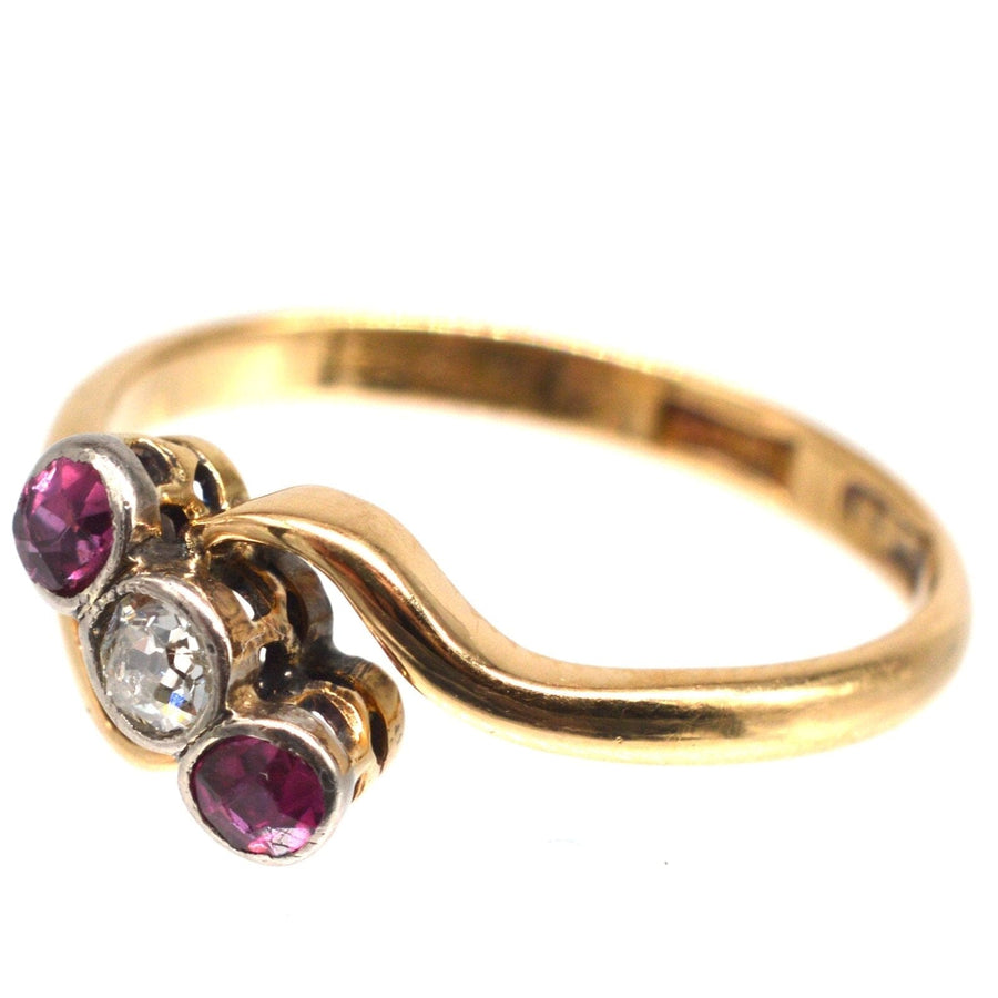 Edwardian 18ct gold crossover ring featuring rubies and diamond in intricate design.