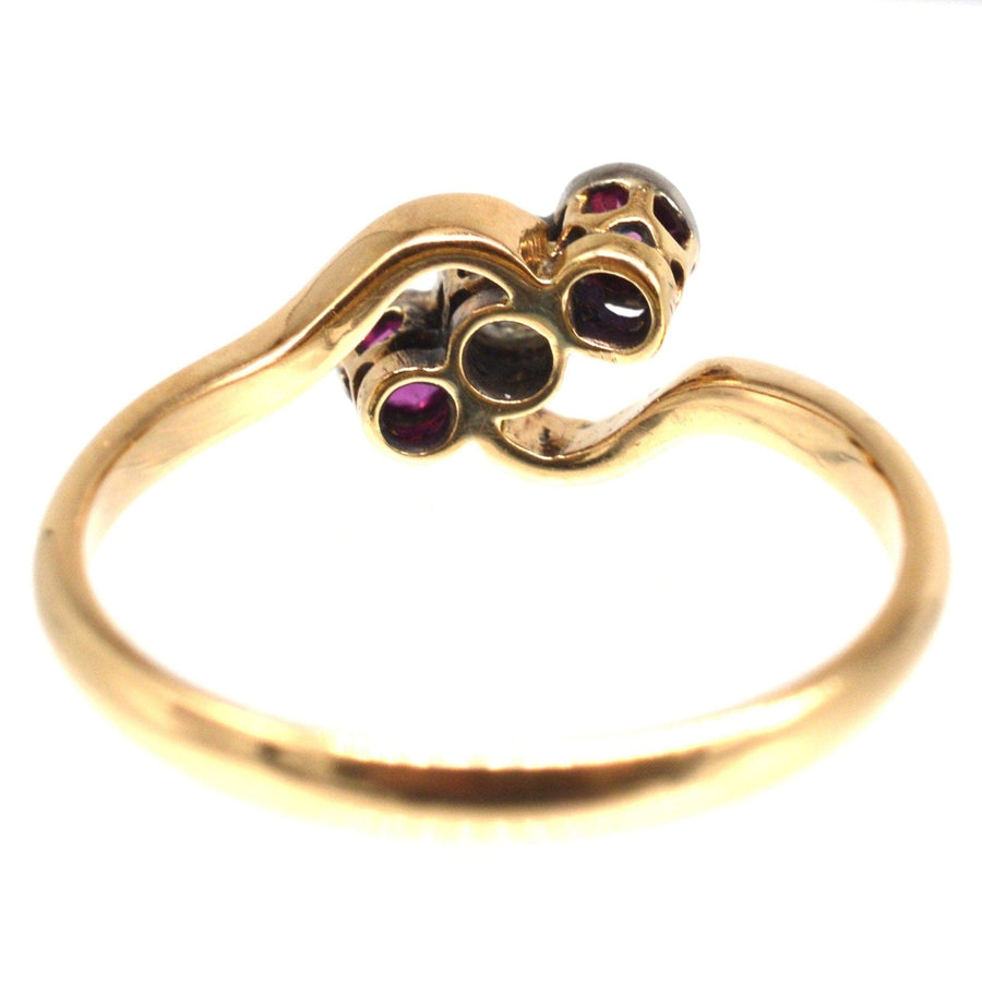 Edwardian 18ct gold and platinum crossover ring with rubies and diamond, Art Nouveau style design.