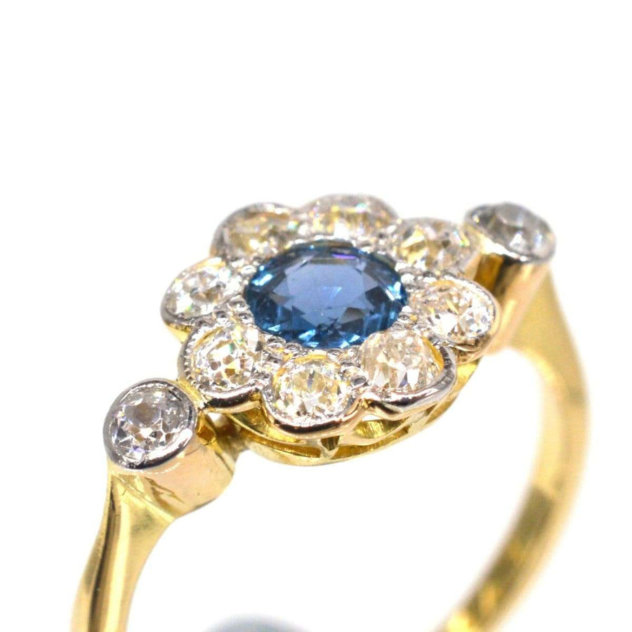 Edwardian 18ct gold and platinum sapphire and diamond cluster ring with cornflower blue sapphire and diamond accents.