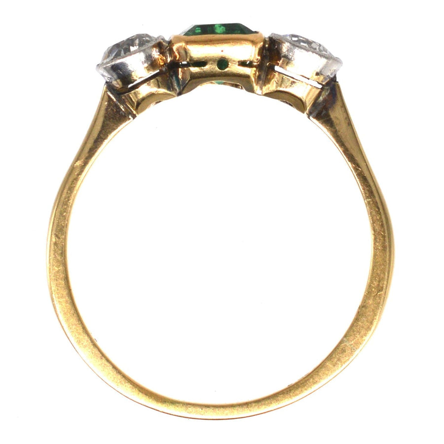 Edwardian 18ct gold ring with vibrant green emerald and two diamonds in a platinum setting.