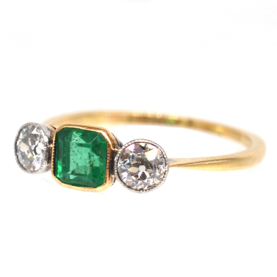 Edwardian 18ct gold and platinum three stone emerald and diamond engagement ring with vibrant green emerald.