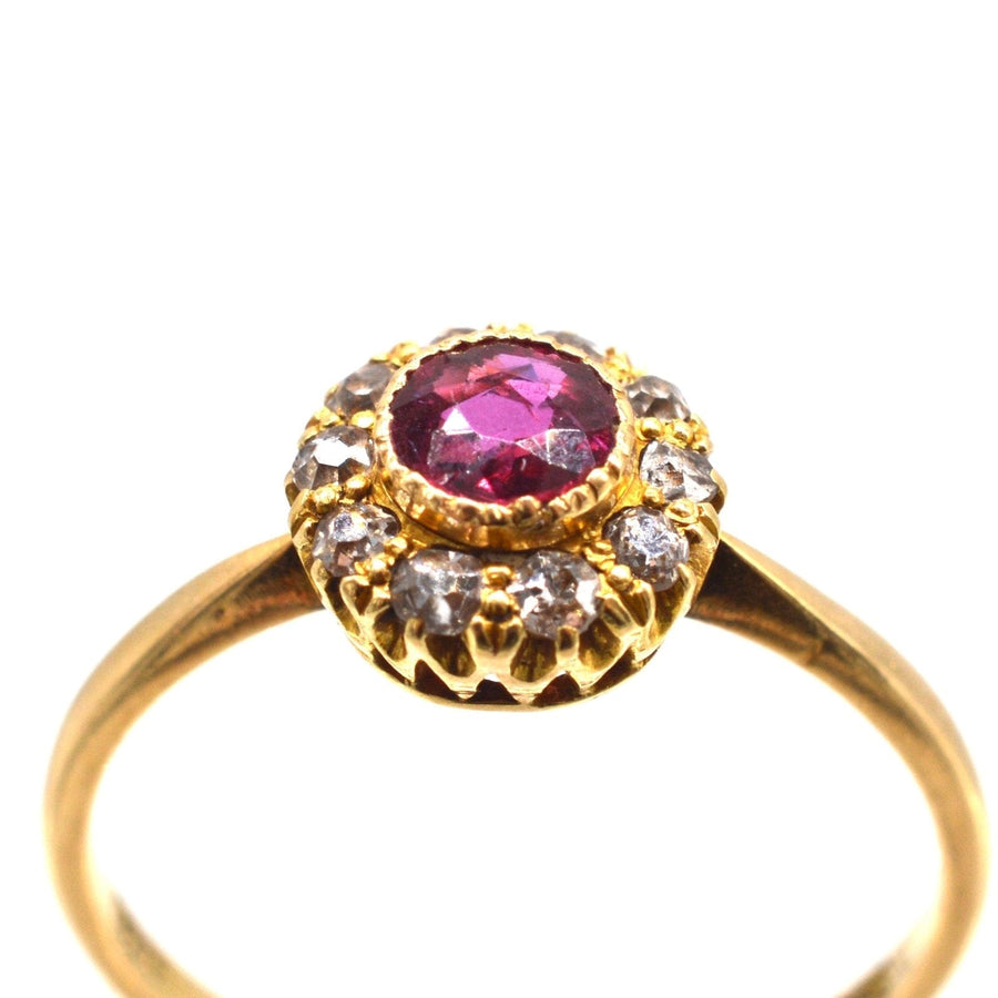 Edwardian 18ct gold ring featuring a central ruby surrounded by ten sparkling diamonds, perfect for engagements or anniversaries.