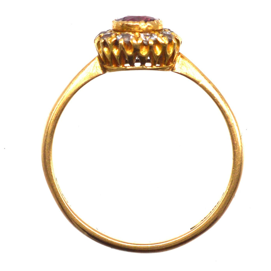 Edwardian 18ct gold ring featuring a central ruby surrounded by sparkling diamonds, ideal for engagements or anniversaries.