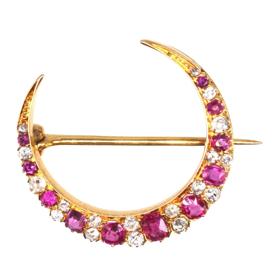 Edwardian 18ct gold crescent moon brooch with ruby and diamond embellishments.