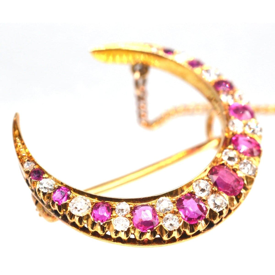 Edwardian 18ct gold brooch featuring ruby and diamond crescent moon design, capturing 19th-century elegance.
