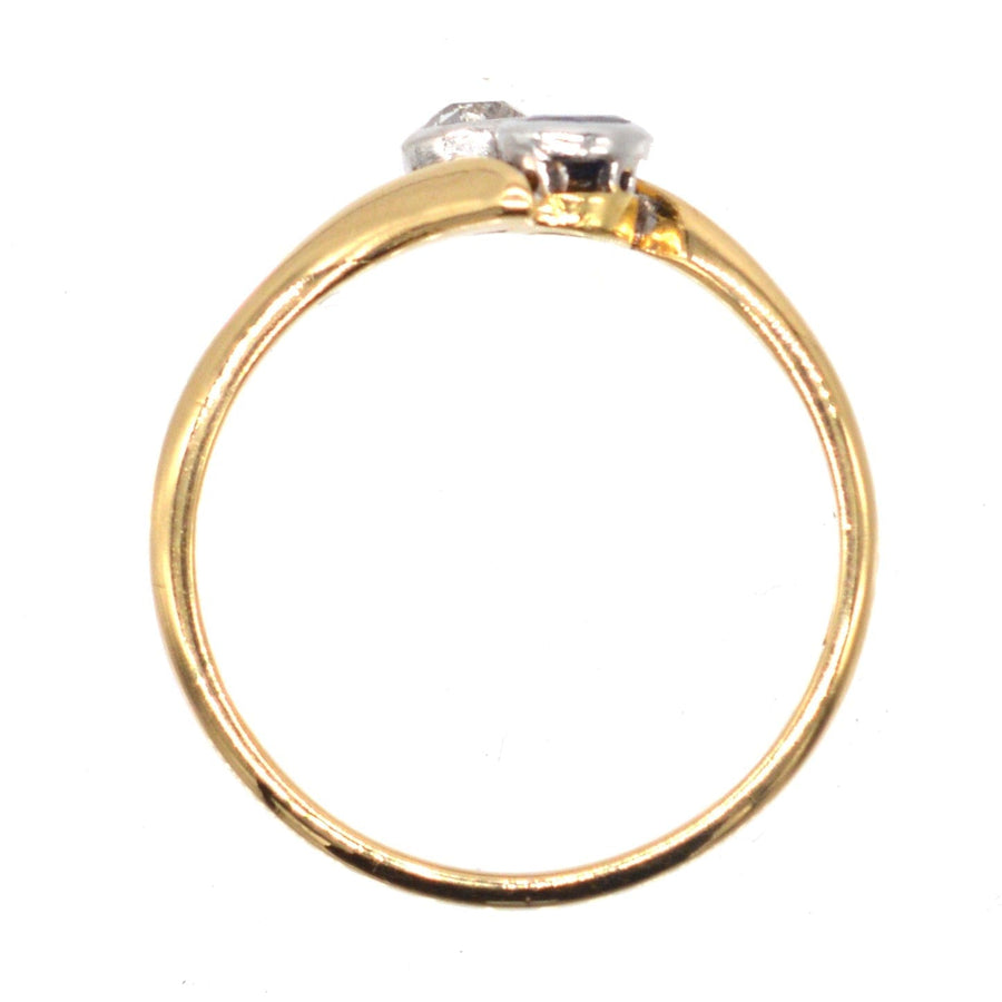 Edwardian 18ct gold crossover ring featuring sapphire and diamond, a romantic 'Toi et Moi' design.