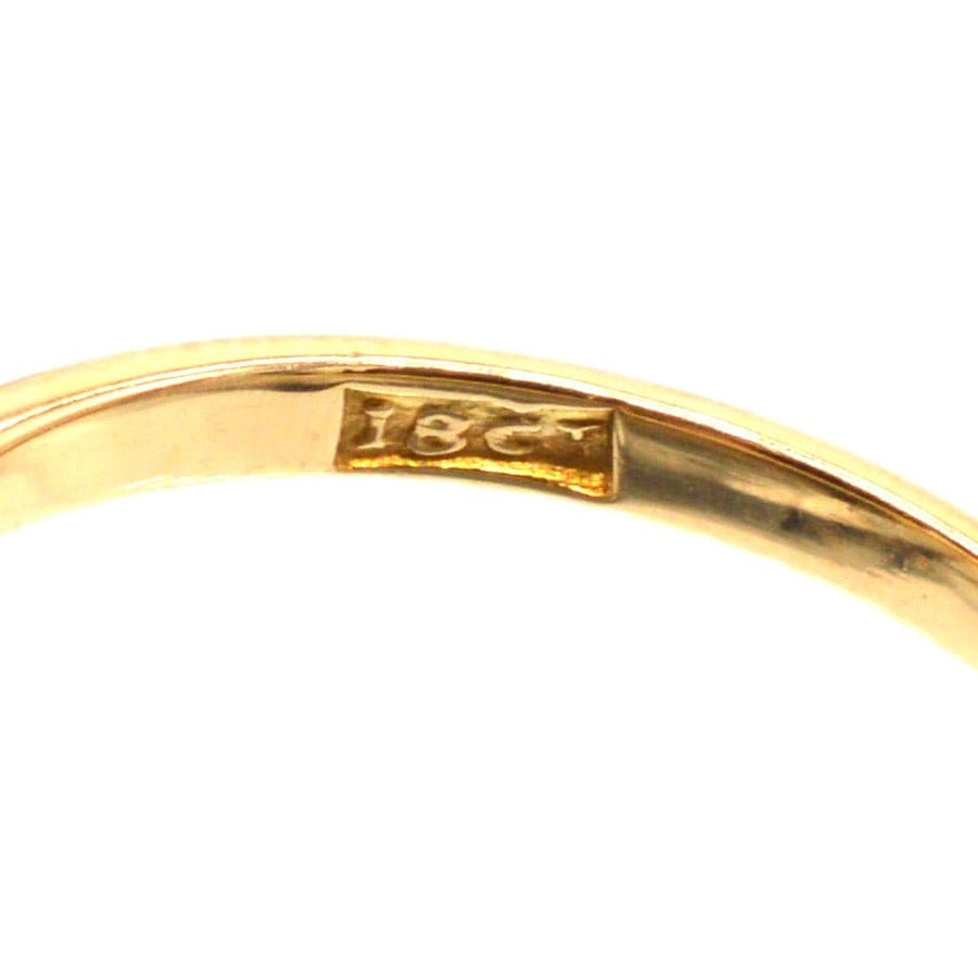 Close-up of gold hallmark showing '18ct' on the inner band of a vintage crossover ring.