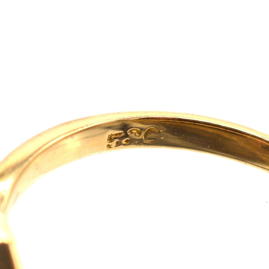 Close-up of the inner band of an Edwardian 18ct gold ring, showcasing its hallmark details.
