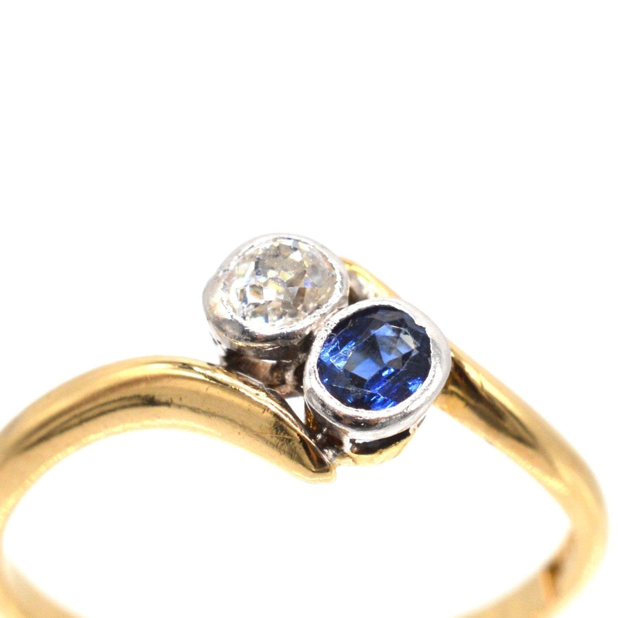 Edwardian 18ct gold crossover ring featuring sapphire and diamond, romantic 'Toi et Moi' design.
