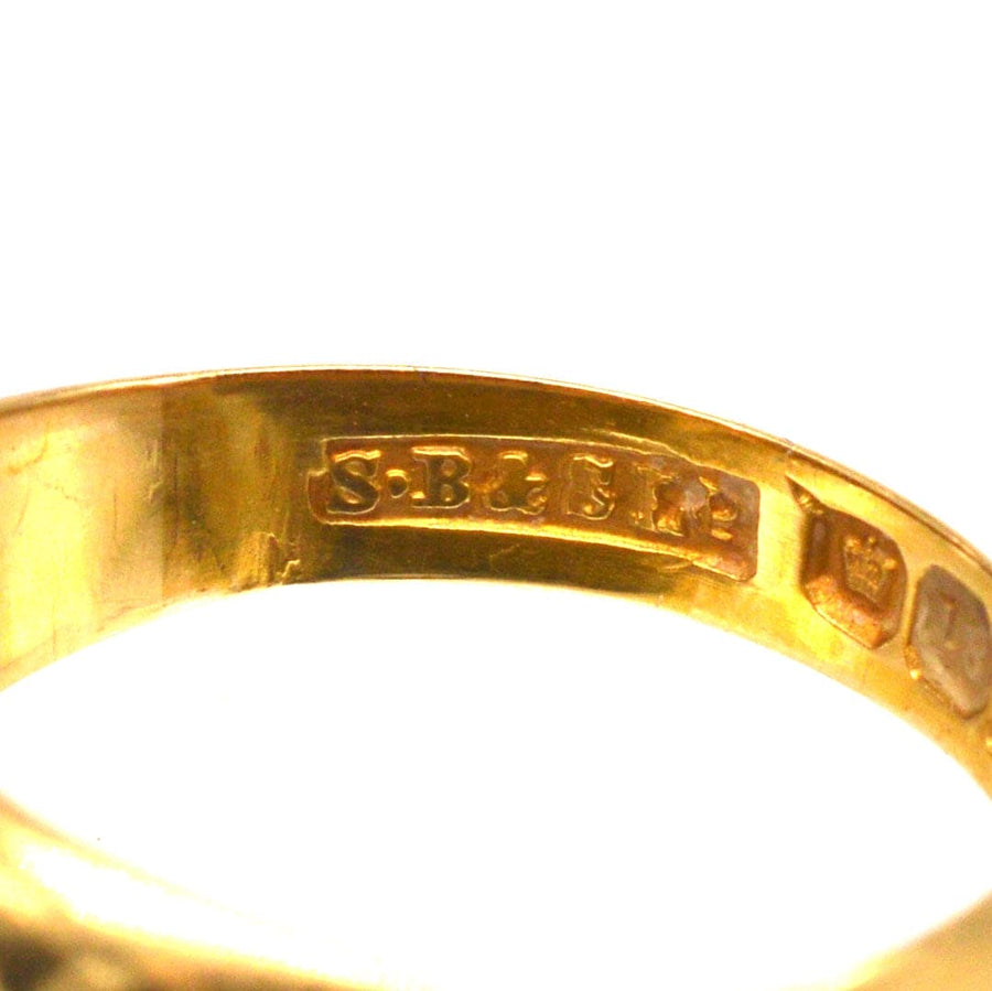 Close-up of the hallmarks on an Edwardian 18ct gold three stone diamond gypsy ring made by S Blanckensee & Son, 1897.
