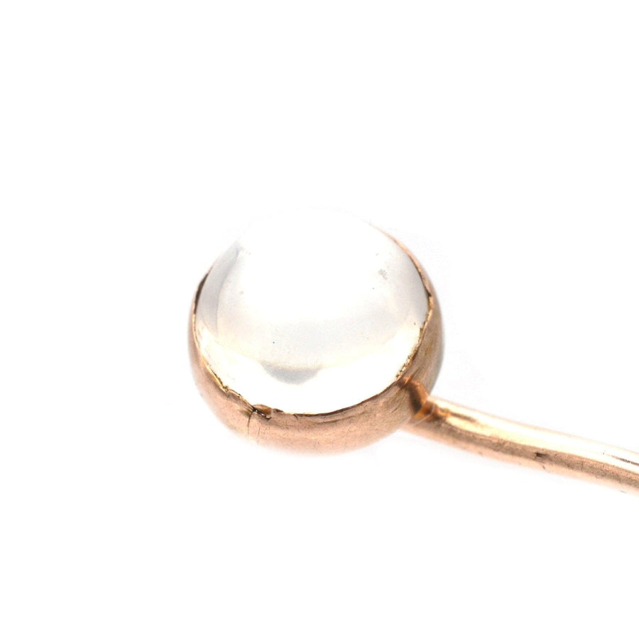 Close-up of an Edwardian 18ct gold tie pin featuring a stunning moonstone, highlighting its translucent beauty.