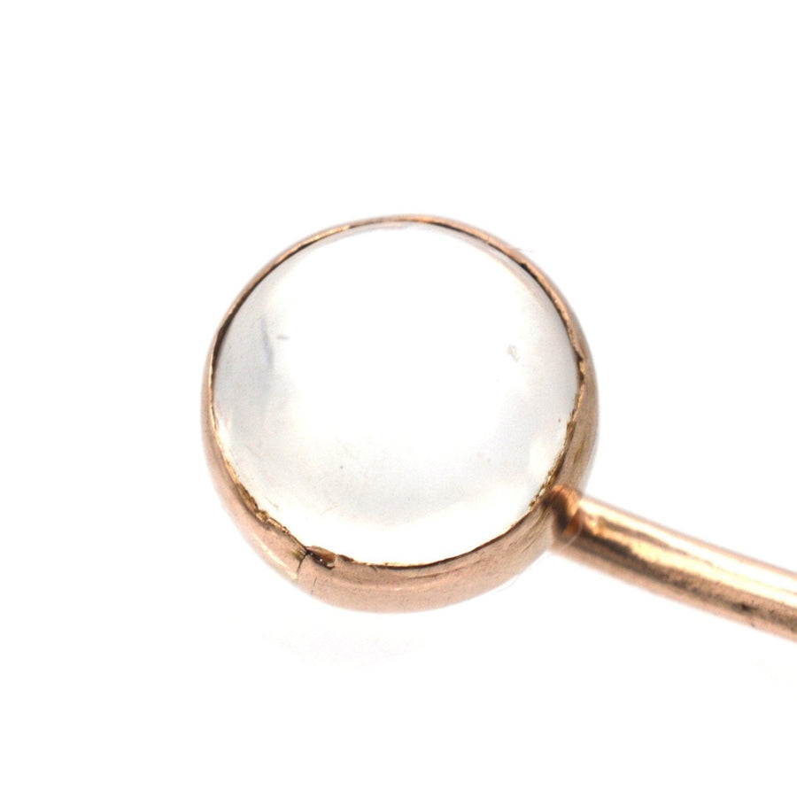 Close-up of an 18ct gold tie pin featuring a luminous moonstone gem, from the Edwardian era.