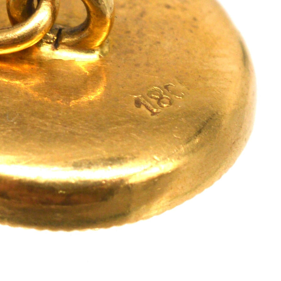 Close-up of 18ct gold mark on Edwardian cufflinks, showcasing craftsmanship and quality.